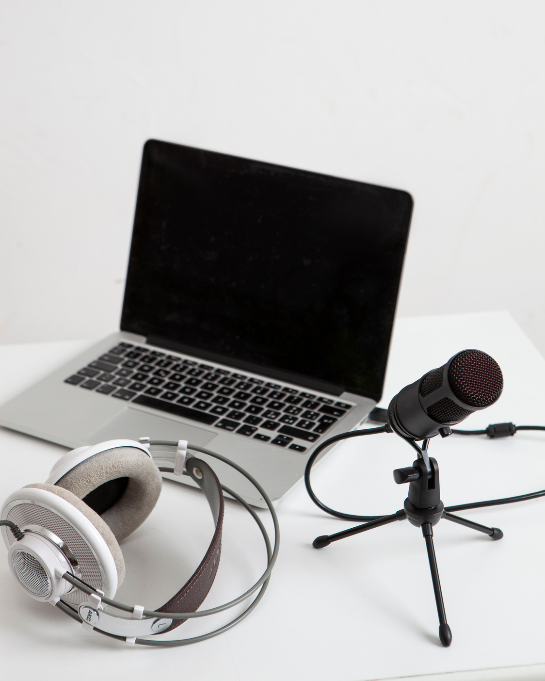 Headphones, Microphone and Laptop on White Desk